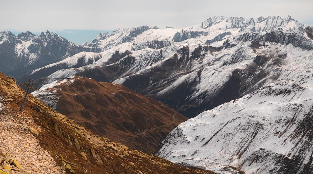 Snow-covered mountains under a hazy sky