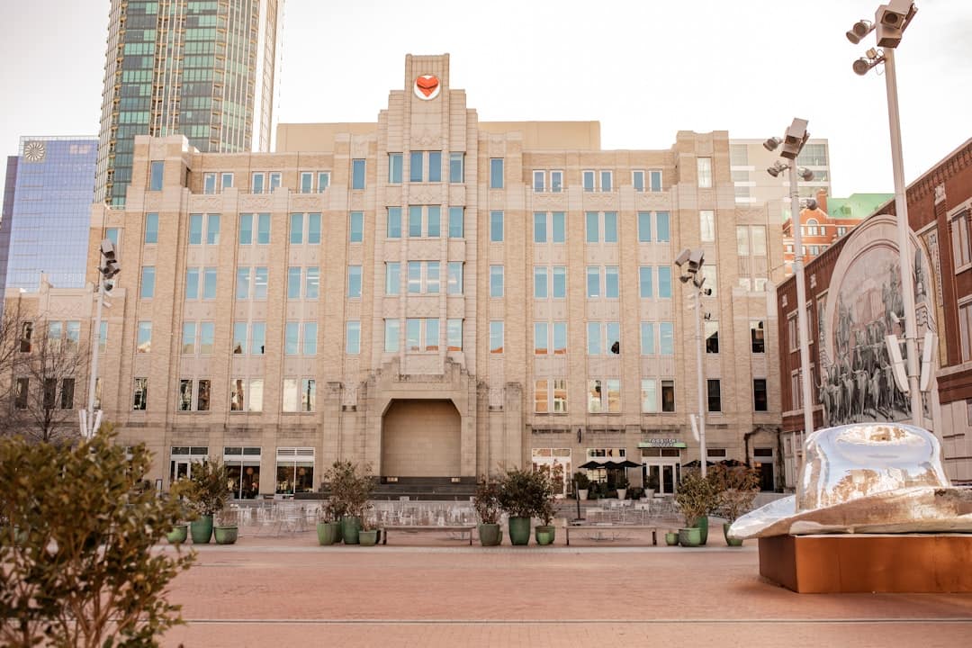a large building with many windows and a statue in front of it