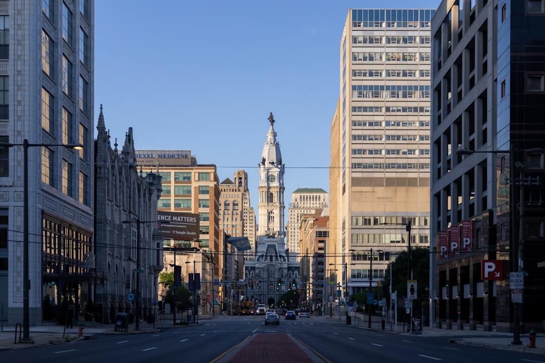 a city street with tall buildings and a clock tower