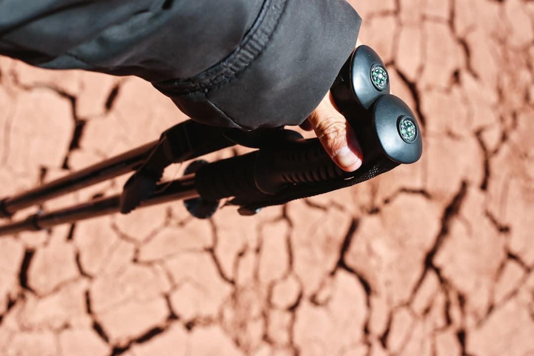 A person holds hiking poles.